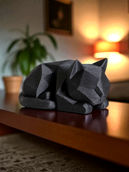 3D printed white low poly cat sculpture resting on a wooden table in a cozy modern interior.